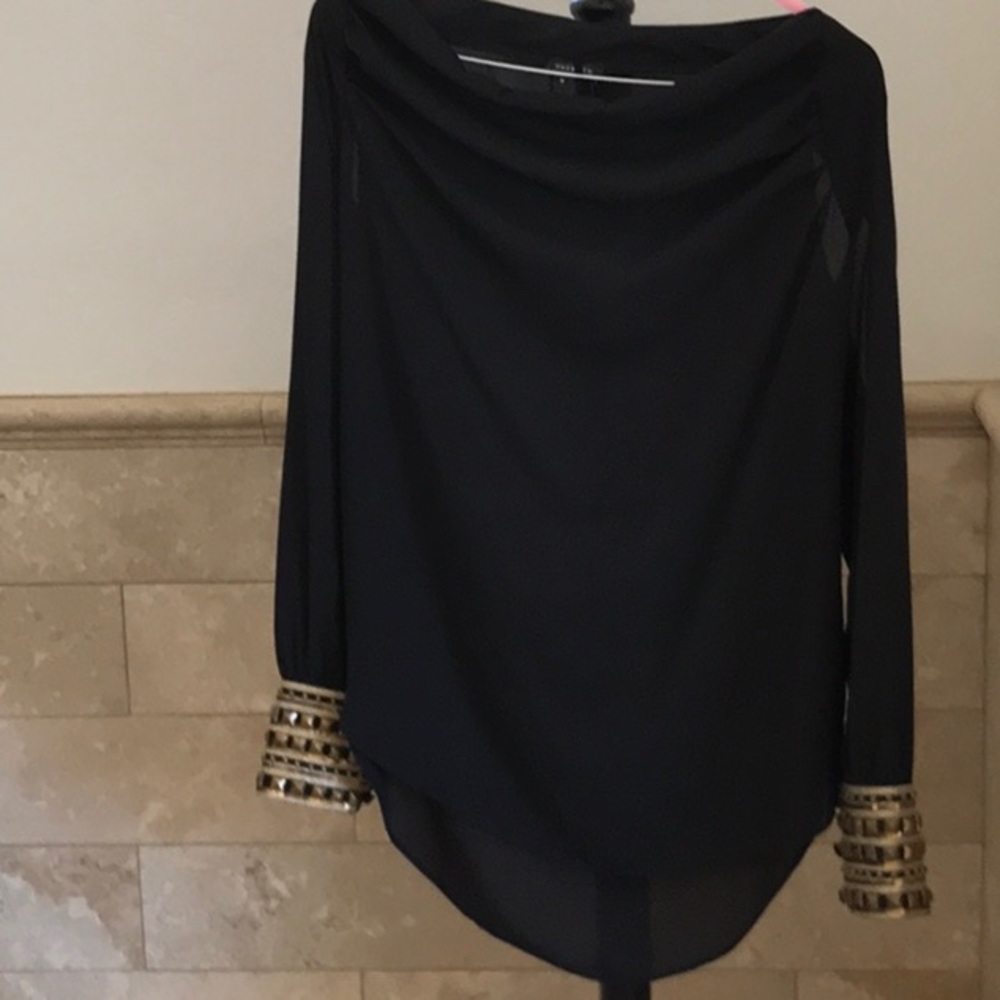 Elegant black top with gold sleeves, vented arms